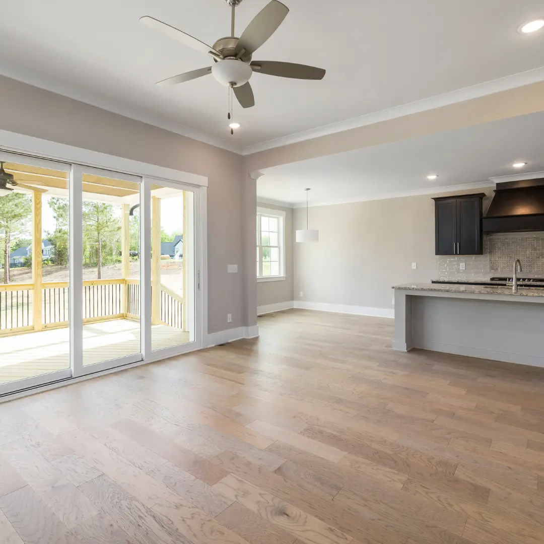 Open living room and kitchen with a newly finished light hardwood floor